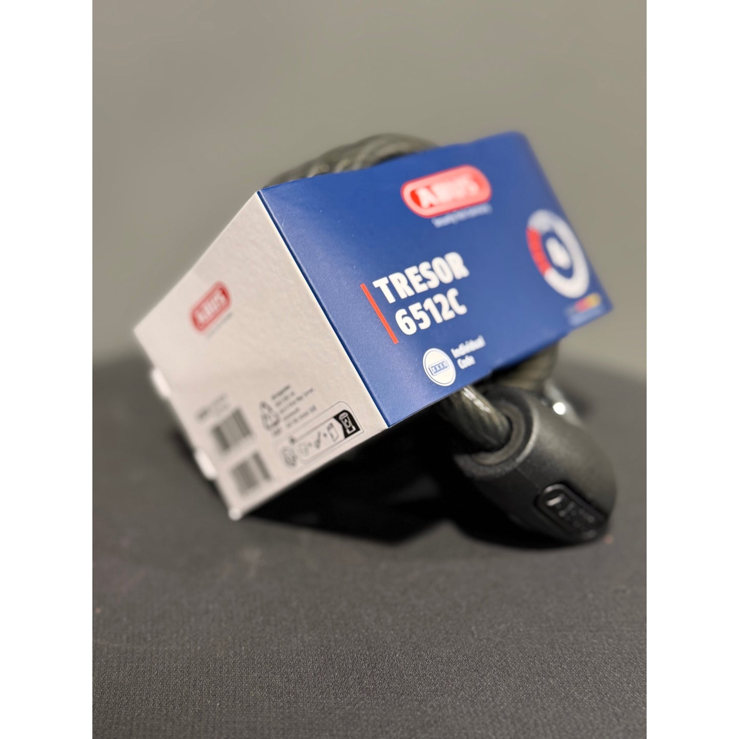 Key fob with 'Tresor 6512C' packaging on a gray surface